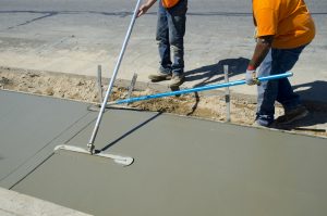 Workers laying concrete for a foundation in Provo